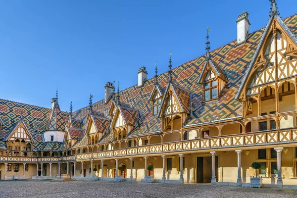 Inner courtyard of the Hospices de Beaune with its colorful glazed tile roofs